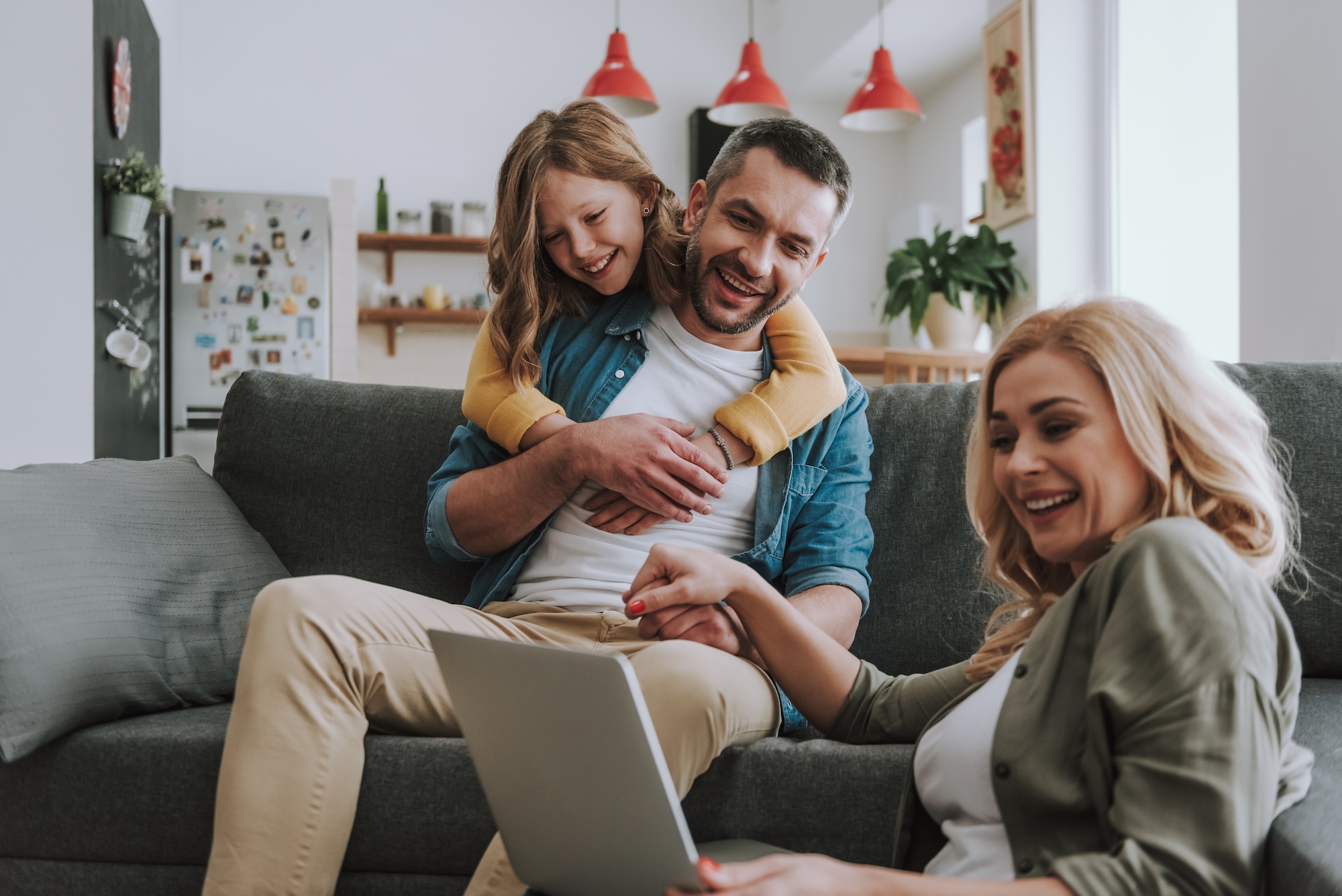 Happy family watching videos on laptop at home